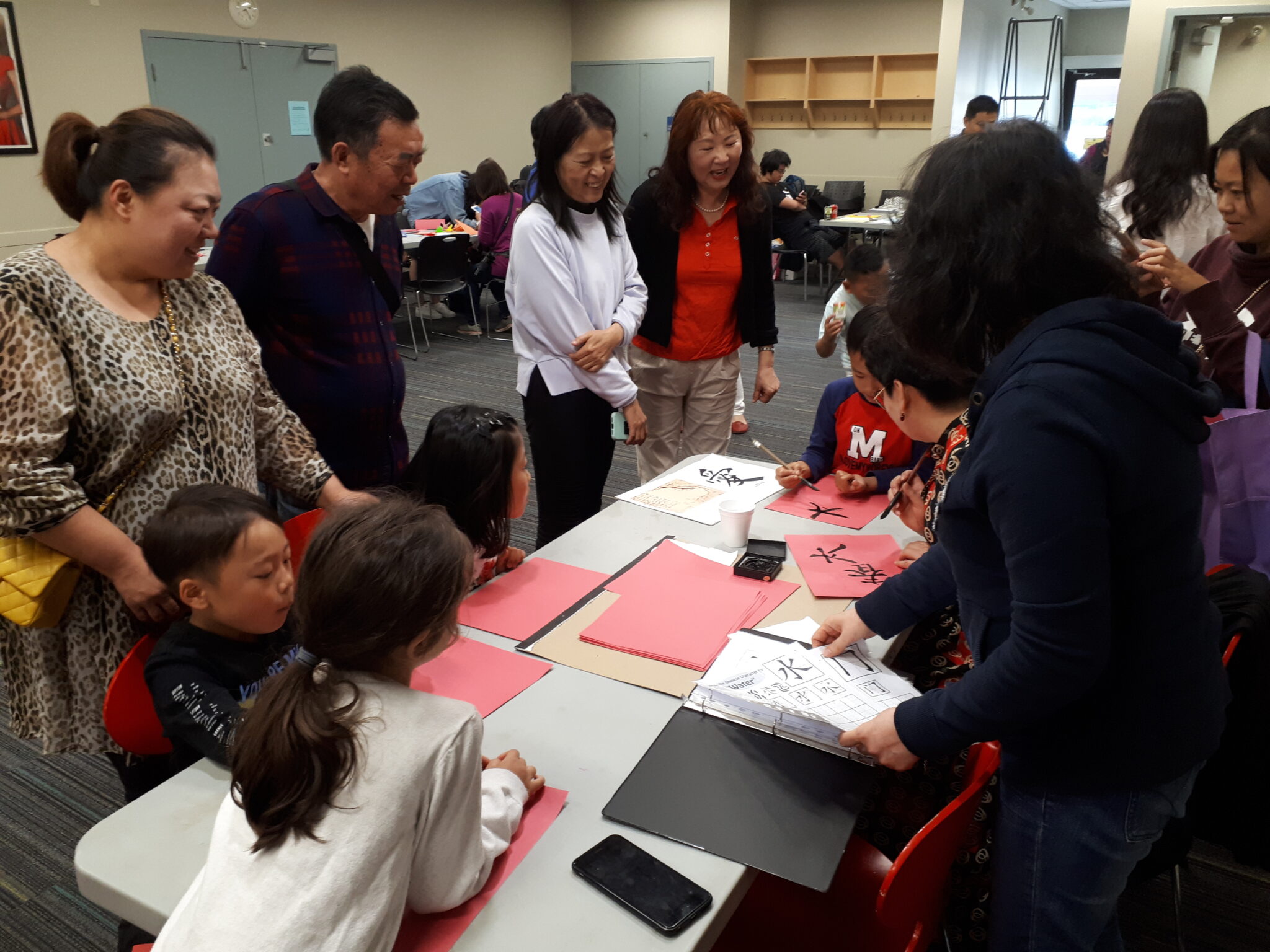 Community members and children participating in a cultural craft activity