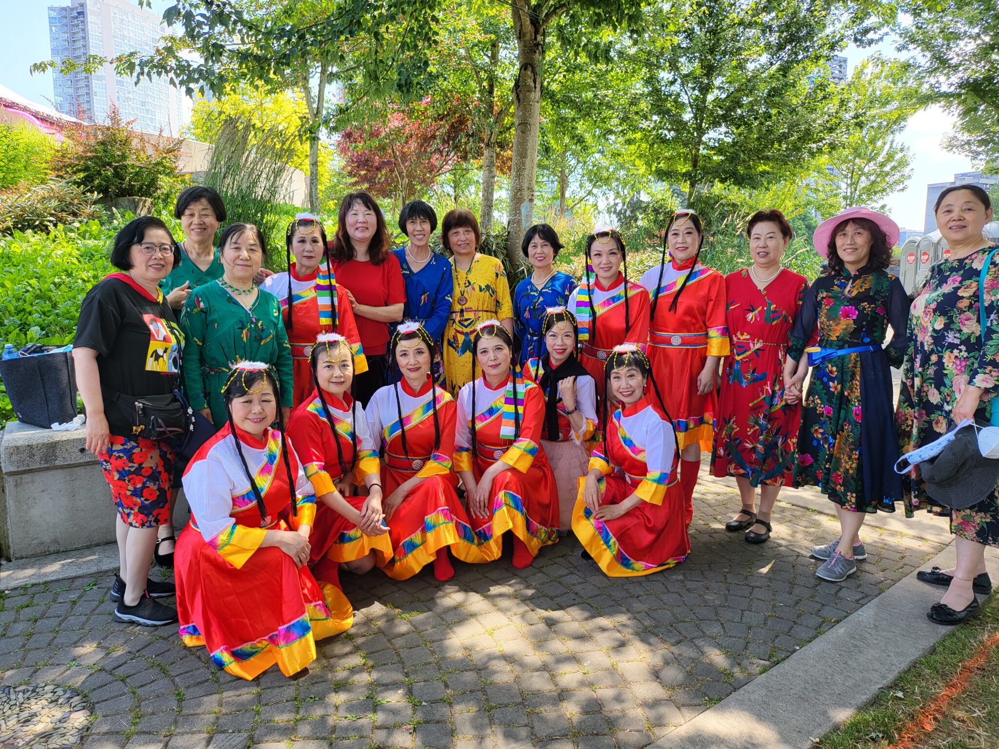 Community members in colourful cultural attire at an outdoor event